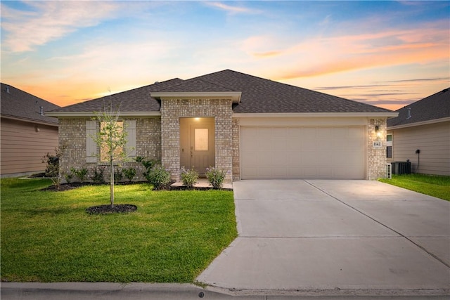 1142 Breebry Dr, Corpus Christi, TX 78415 - view of front of home with brick siding, an attached garage, driveway, a lawn, and a shingled roof