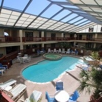 view of pool featuring a lanai, a patio area, and a community hot tub