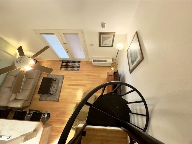 staircase featuring ceiling fan and wood-type flooring