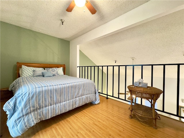 bedroom featuring wood-type flooring, a textured ceiling, and ceiling fan