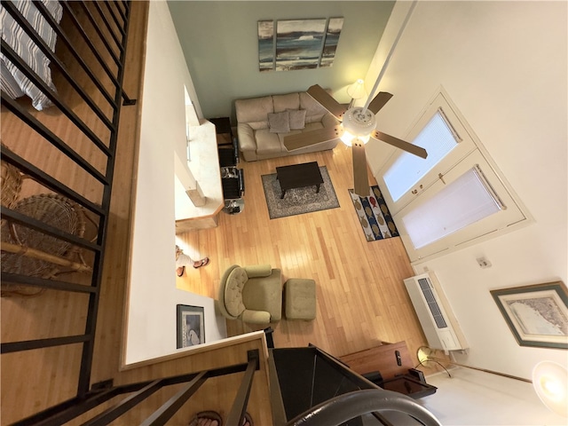 interior space with ceiling fan, a towering ceiling, and heating unit