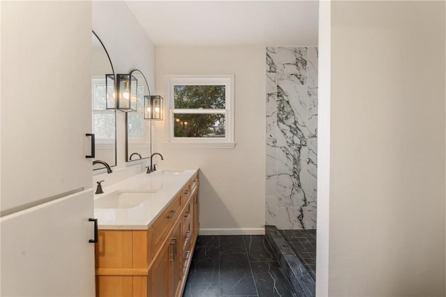 bathroom featuring vanity and tiled shower