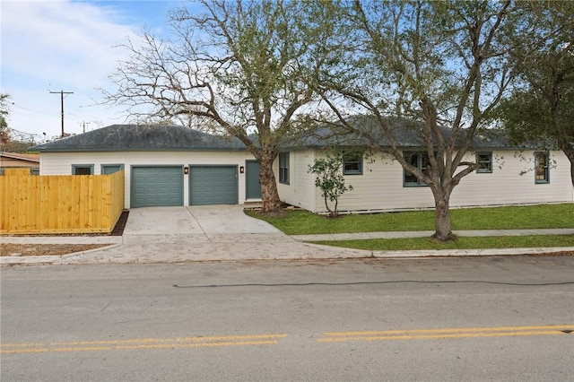 single story home featuring a garage and a front yard