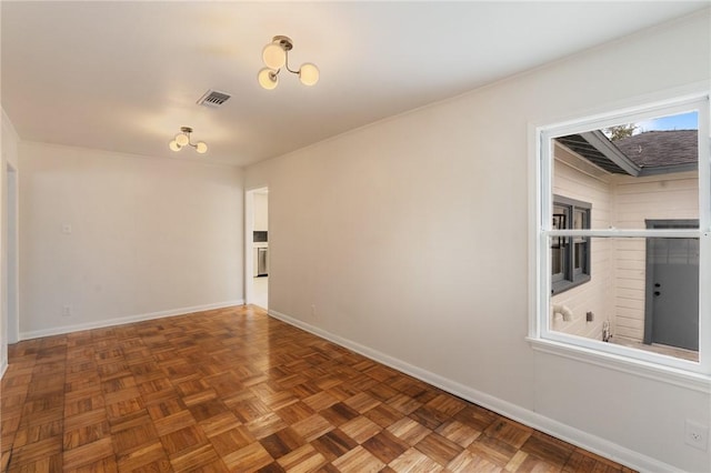 spare room with dark parquet floors