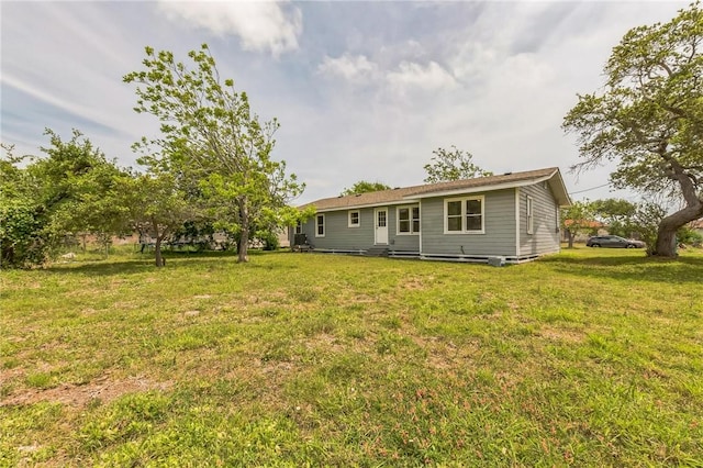 130 N Houston St, Aransas Pass, TX 78336 - rear view of property featuring a lawn