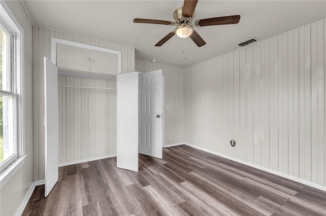130 N Houston St, Aransas Pass, TX 78336 - unfurnished bedroom with a closet, wood finished floors, visible vents, and ceiling fan