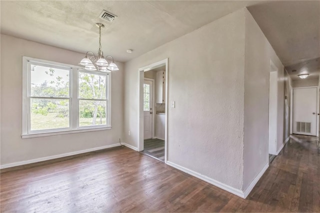 130 N Houston St, Aransas Pass, TX 78336 - interior space with visible vents, baseboards, a notable chandelier, and dark wood-style floors