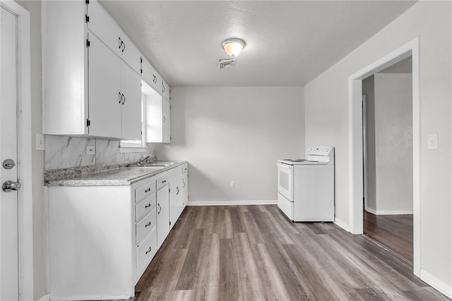 130 N Houston St, Aransas Pass, TX 78336 - kitchen featuring white cabinets, a sink, dark wood finished floors, light countertops, and white range with electric cooktop