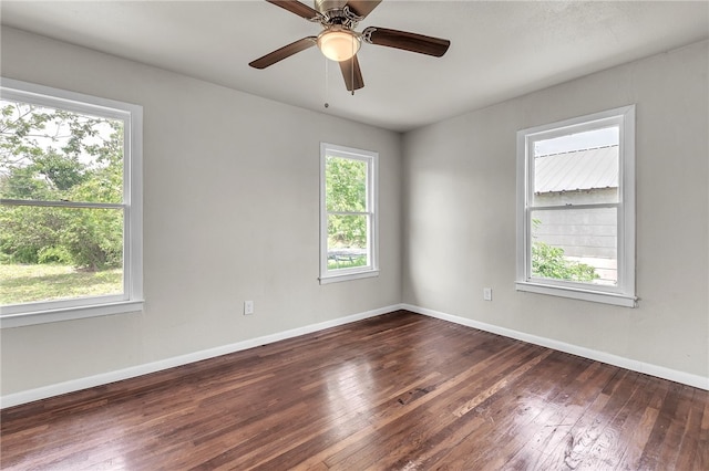 130 N Houston St, Aransas Pass, TX 78336 - unfurnished room featuring baseboards, a wealth of natural light, a ceiling fan, and dark wood-style floors