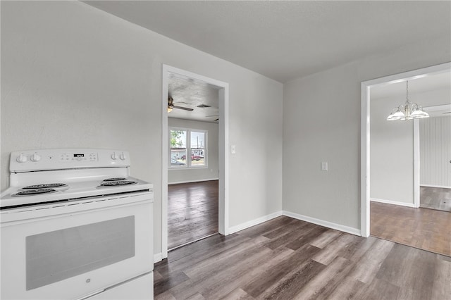 130 N Houston St, Aransas Pass, TX 78336 - kitchen featuring electric range, baseboards, wood finished floors, and ceiling fan with notable chandelier