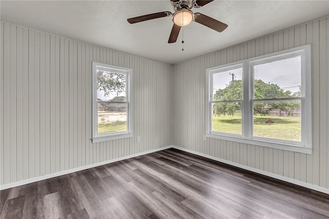 130 N Houston St, Aransas Pass, TX 78336 - unfurnished room featuring a wealth of natural light, a ceiling fan, and dark wood-type flooring