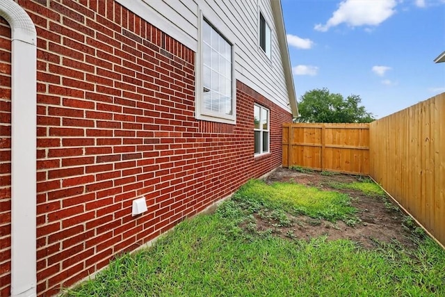 7821 Kingshire Dr, Corpus Christi, TX 78413 - view of side of home with brick siding and a fenced backyard