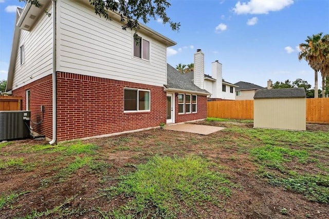 7821 Kingshire Dr, Corpus Christi, TX 78413 - back of property with brick siding, a fenced backyard, a storage unit, and a patio