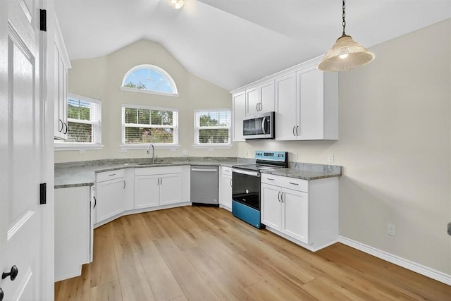 7821 Kingshire Dr, Corpus Christi, TX 78413 - kitchen featuring appliances with stainless steel finishes, lofted ceiling, light wood finished floors, and white cabinets