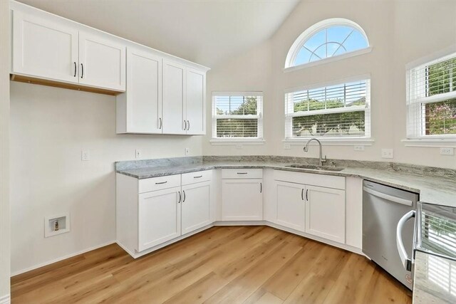 7821 Kingshire Dr, Corpus Christi, TX 78413 - kitchen with stainless steel dishwasher, light wood-type flooring, plenty of natural light, light stone countertops, and vaulted ceiling