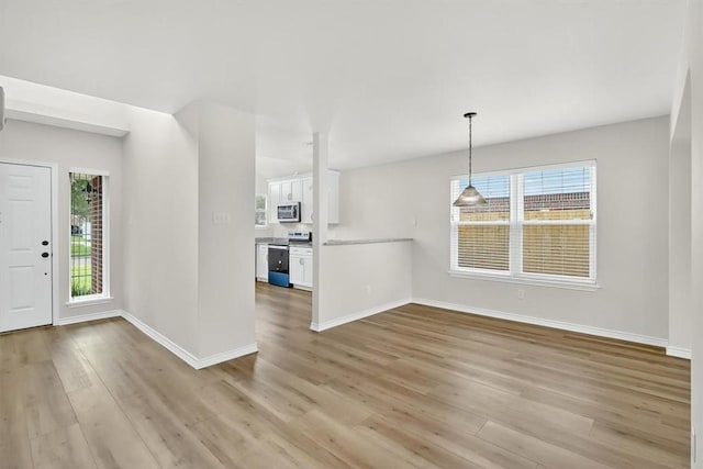 7821 Kingshire Dr, Corpus Christi, TX 78413 - unfurnished living room with light wood-style flooring