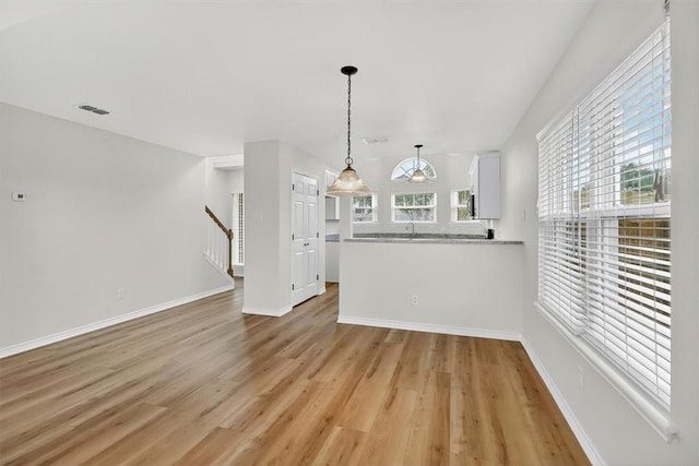 7821 Kingshire Dr, Corpus Christi, TX 78413 - unfurnished living room featuring light wood finished floors and stairway