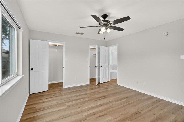 7821 Kingshire Dr, Corpus Christi, TX 78413 - unfurnished bedroom featuring light wood-style flooring, a spacious closet, and ceiling fan