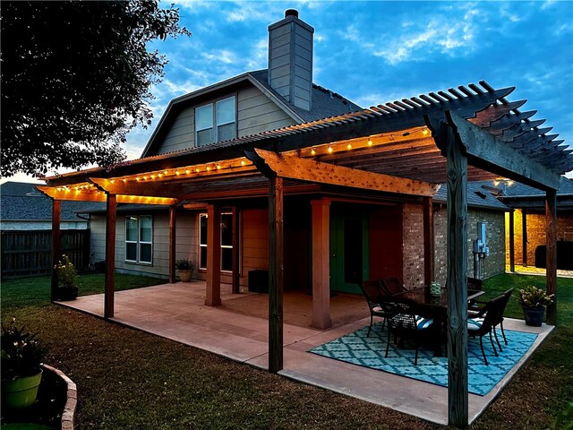 back of property featuring a pergola and a patio area