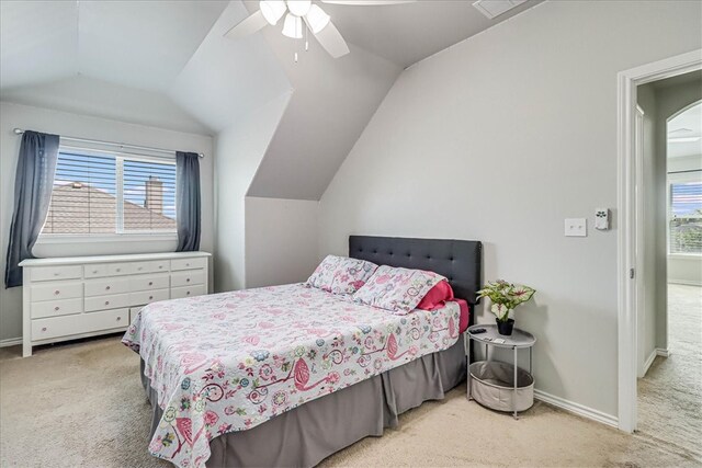 carpeted bedroom with vaulted ceiling and ceiling fan