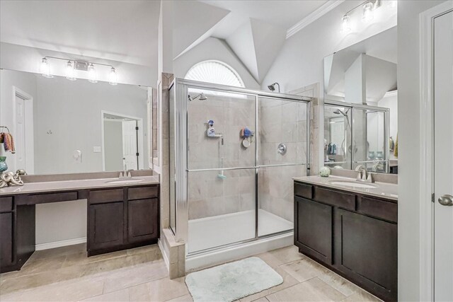 bathroom featuring tile patterned floors, vanity, vaulted ceiling, and a shower with door