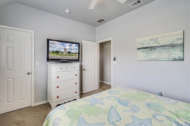 bedroom featuring carpet flooring, lofted ceiling, and ceiling fan