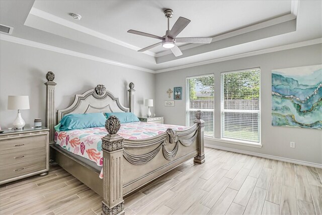 bedroom featuring crown molding, ceiling fan, and a raised ceiling