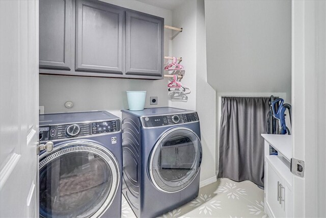 laundry room with cabinets and separate washer and dryer