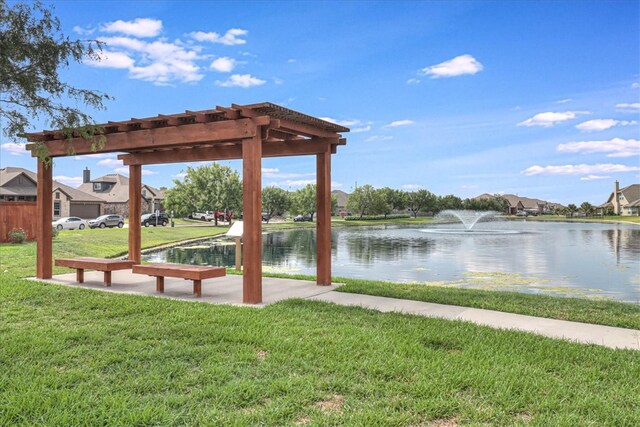 view of dock with a water view and a lawn