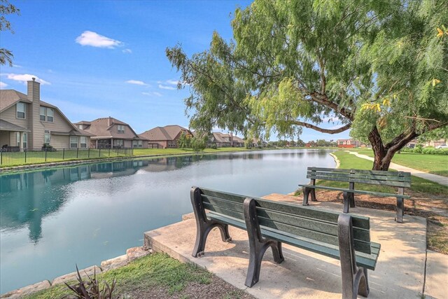 exterior space with a water view and a yard