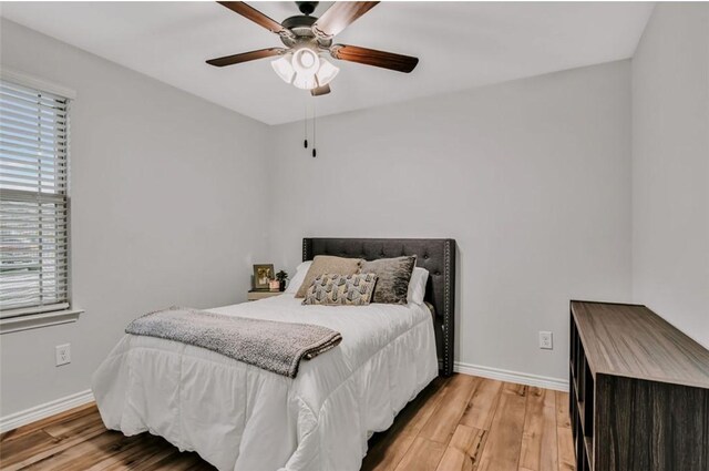 7602 Bayley Ln, Corpus Christi, TX 78414 - bedroom with wood finished floors, baseboards, and a ceiling fan