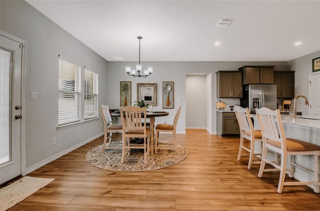 7602 Bayley Ln, Corpus Christi, TX 78414 - dining room with a chandelier, light wood finished floors, recessed lighting, and baseboards