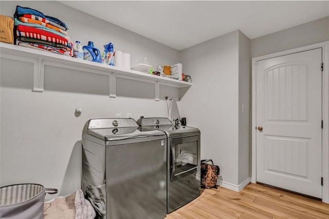 7602 Bayley Ln, Corpus Christi, TX 78414 - laundry room with washing machine and clothes dryer, light wood-style floors, and baseboards