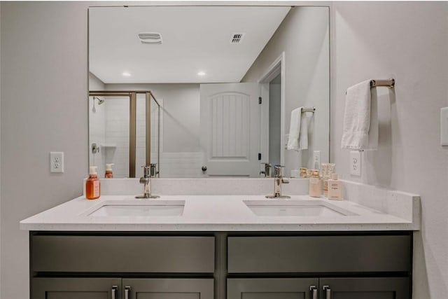 7602 Bayley Ln, Corpus Christi, TX 78414 - bathroom featuring double vanity, a shower stall, and recessed lighting