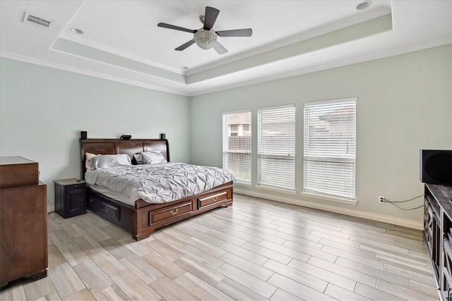 bedroom with ceiling fan, light hardwood / wood-style flooring, and a raised ceiling