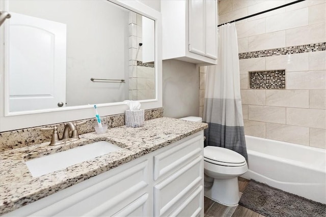 full bathroom featuring toilet, shower / bath combination with curtain, hardwood / wood-style flooring, and vanity