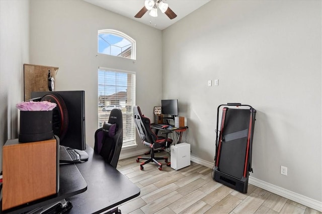 office area with ceiling fan and light hardwood / wood-style floors