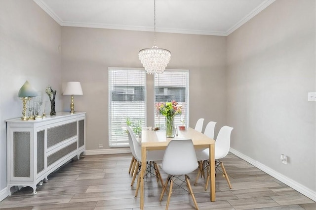 dining room featuring wood-type flooring, a notable chandelier, and crown molding