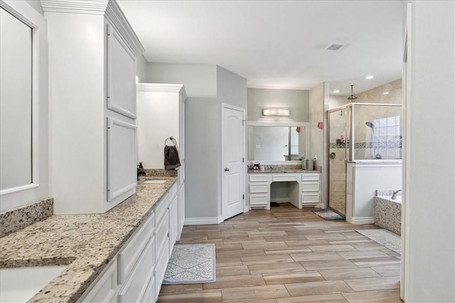 bathroom with vanity and plus walk in shower