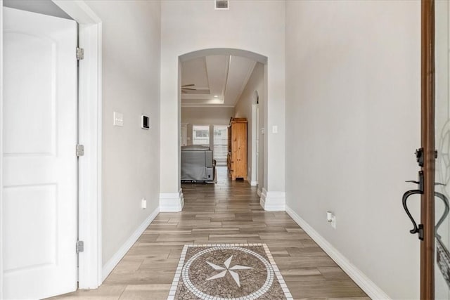 hall with a raised ceiling