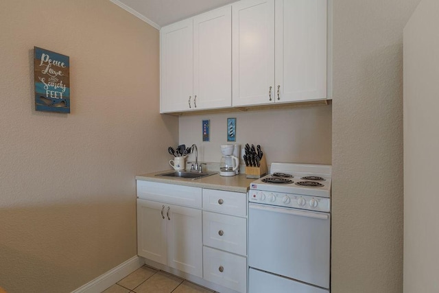 kitchen featuring white cabinetry, sink, white electric range, and light tile patterned flooring