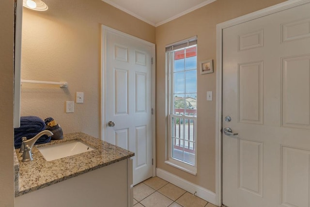 bathroom with crown molding, tile patterned floors, and vanity