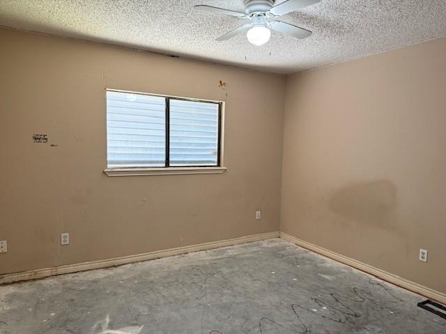 6026 Blue Water Dr, Corpus Christi, TX 78415 - empty room with a textured ceiling, a ceiling fan, and baseboards