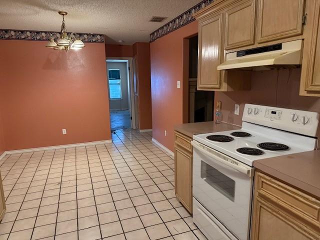 6026 Blue Water Dr, Corpus Christi, TX 78415 - kitchen featuring white electric stove, under cabinet range hood, a chandelier, light tile patterned floors, and a textured ceiling