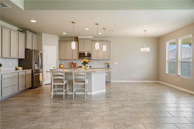 2538 Las Estrellas St, Corpus Christi, TX 78414 - kitchen with appliances with stainless steel finishes, decorative backsplash, recessed lighting, a kitchen island, and a kitchen breakfast bar