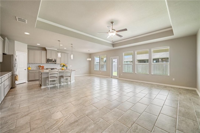 2538 Las Estrellas St, Corpus Christi, TX 78414 - living area with a raised ceiling, ceiling fan, recessed lighting, baseboards, and ornamental molding