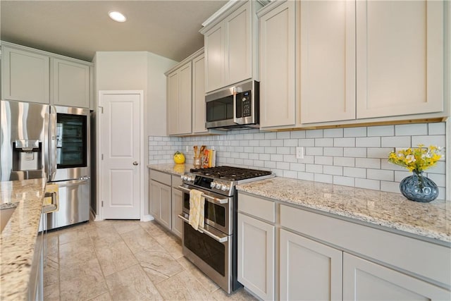 2538 Las Estrellas St, Corpus Christi, TX 78414 - kitchen with stainless steel appliances, backsplash, light stone countertops, and recessed lighting
