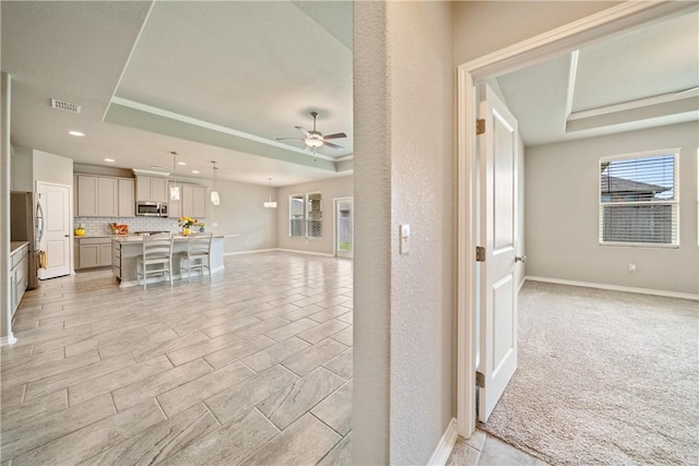 2538 Las Estrellas St, Corpus Christi, TX 78414 - unfurnished living room featuring ceiling fan, a tray ceiling, recessed lighting, and baseboards