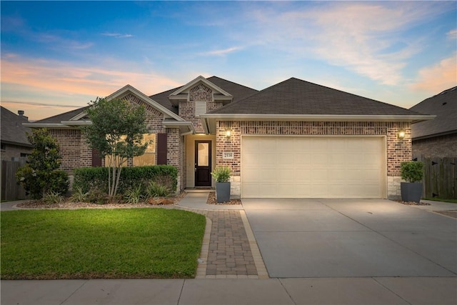 2538 Las Estrellas St, Corpus Christi, TX 78414 - view of front of house with brick siding, driveway, a garage, and roof with shingles