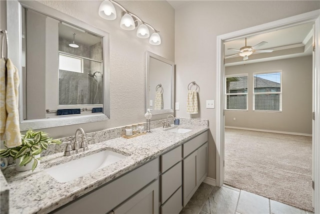 2538 Las Estrellas St, Corpus Christi, TX 78414 - bathroom with a shower stall, double vanity, ceiling fan, tile patterned floors, and baseboards